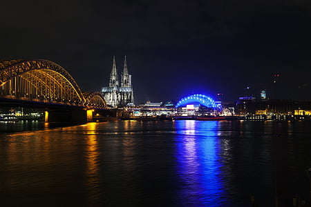 two yellow and blue lighted arch bridge view during night thumbnail