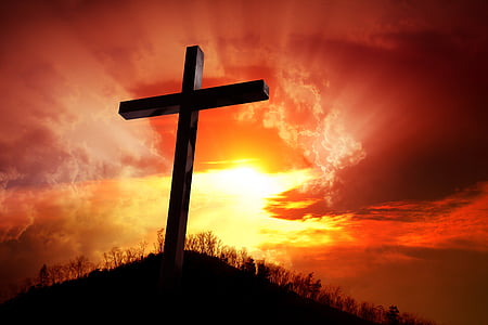 brown wooden cross silhouette on top of mount during golden hour thumbnail