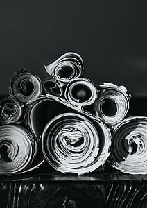 grayscale photo of rolled books thumbnail