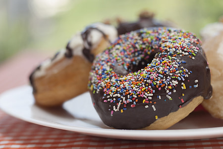 chocolate covered doughnut on white plate thumbnail