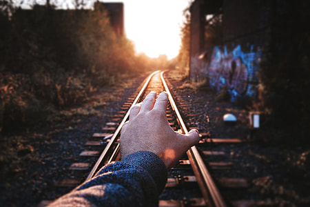 Man’s hand on train tracks thumbnail