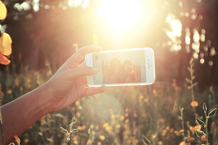 person holding iPhone 6 taking selfie thumbnail