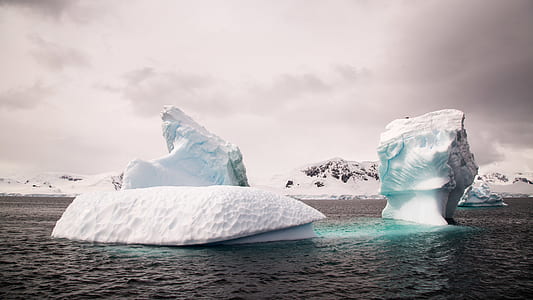 two icebergs on body of water thumbnail