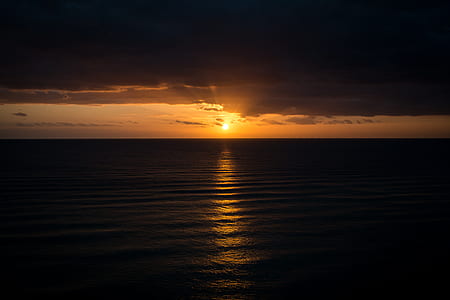 silhouette of calm water beach thumbnail