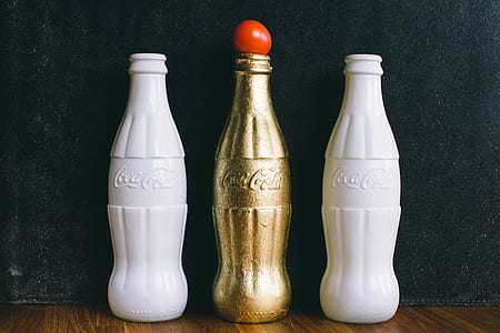 Three White and Brass Coca-cola Bottles thumbnail