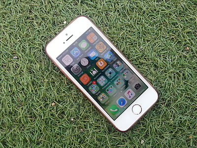 gold iPhone 5s on green grass thumbnail