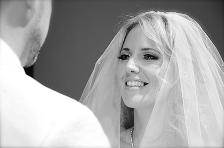 woman wearing wedding veil standing in front of man thumbnail