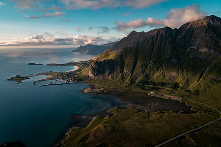 aerial photo of mountain near body of water thumbnail