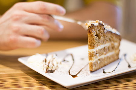 person holding spoon slicing cake thumbnail