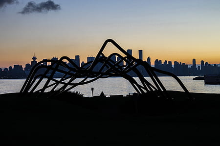 silhouette photo of metal arch frame beside water thumbnail