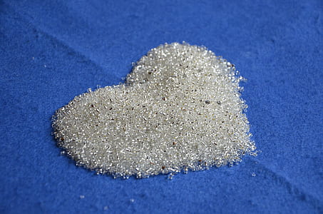 silver-colored heart decor on blue textile thumbnail