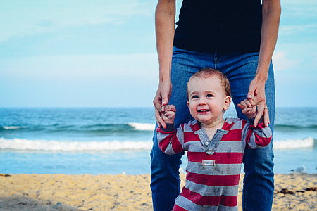 toddler wearing gray and red striped top during daytime thumbnail