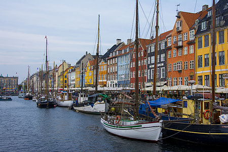photo of assorted-color buildings near body of water with boats thumbnail