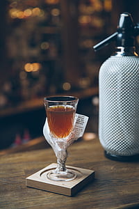 beverage filled drinking glass on wooden surface thumbnail