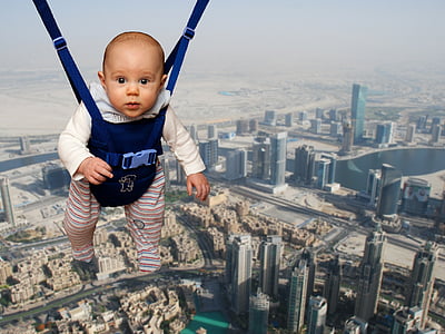 baby in blue hanging jumper thumbnail