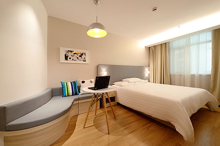 gray bed frame beside white and brown wooden side table thumbnail