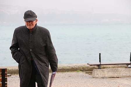 man holding book walking near dock thumbnail