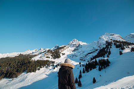 man walking through peak of mountain thumbnail