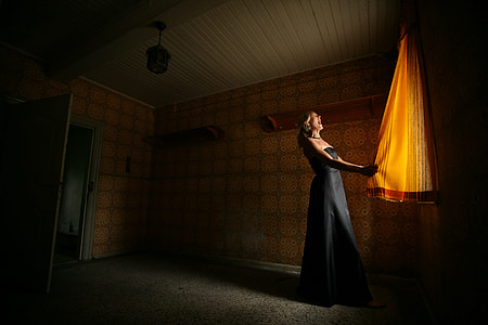 woman holding orange curtain thumbnail
