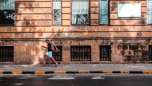 Man Walking at the Walkway Near Curb thumbnail
