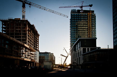 two black tower cranes on buildings thumbnail