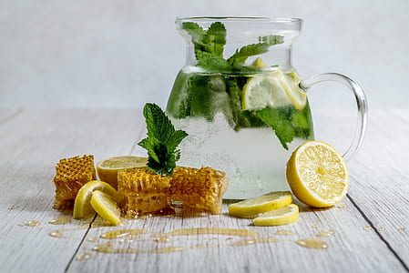 clear glass pitcher with green vegetable and slice lemon thumbnail