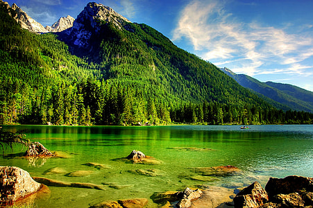 body of water beside mountain thumbnail