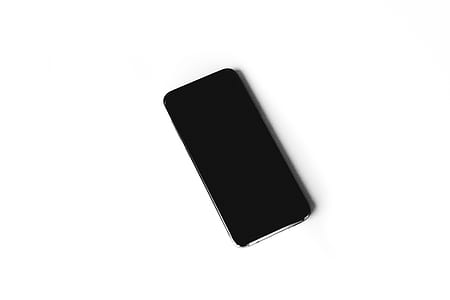 turned-off black smartphone on white surface thumbnail