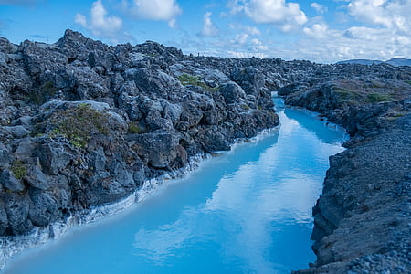 body of water surrounded by rock formation thumbnail