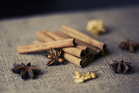 cinnamon rolls near star anise on grey textile thumbnail