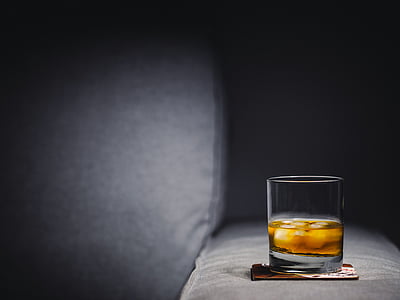 clear shot glass with brown liquid thumbnail