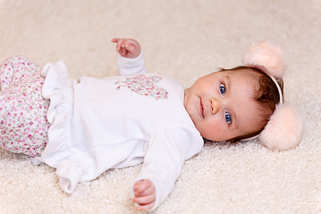 child lying on white fur textile thumbnail