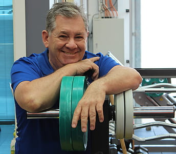 man leaning to green dumbbell thumbnail