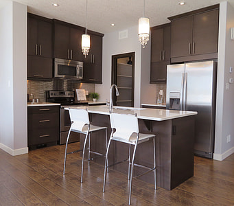 two white and grey barstools beside kitchen island inside kitchen thumbnail