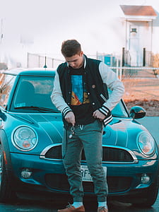 man standing in front of the car beside the road thumbnail