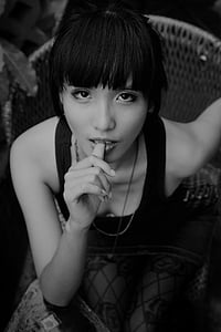 grayscale photo of woman with tank top thumb sucking thumbnail