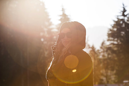 woman wearing sunglasses standing in front of pine trees thumbnail