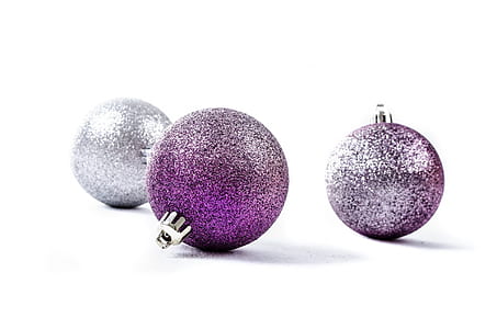 two purple and one silver baubles on white background thumbnail