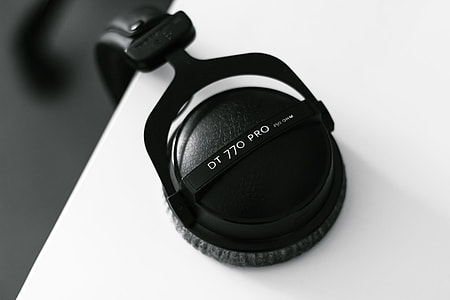 black headphones on white surface thumbnail