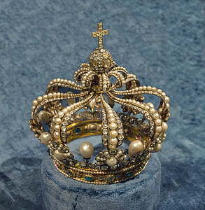 gold-colored crown on gray cushion thumbnail