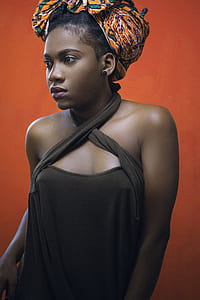 woman standing near orange wall thumbnail