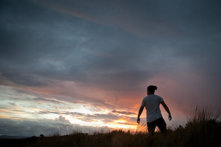 man standing over hill taken at sunset thumbnail