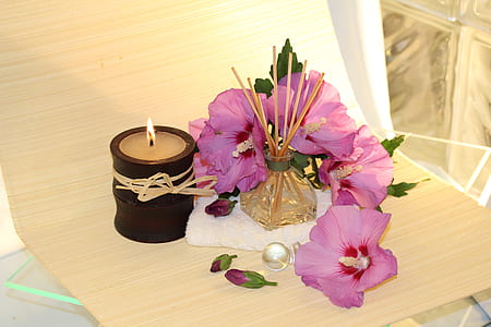 purple flower beside beige candle thumbnail