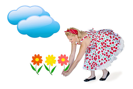 woman wearing white and red floral sleeveless dress picking a pink flower thumbnail