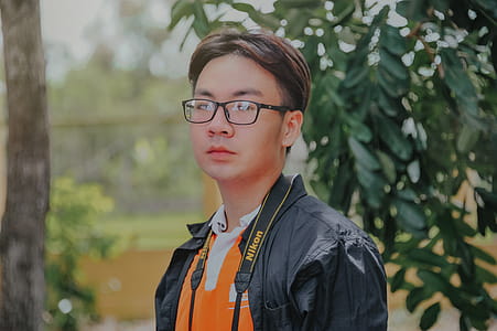 Man in Black Collared Top Posing for Photo thumbnail