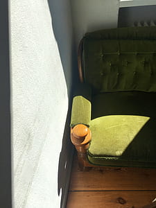 green armchair besides the wall thumbnail