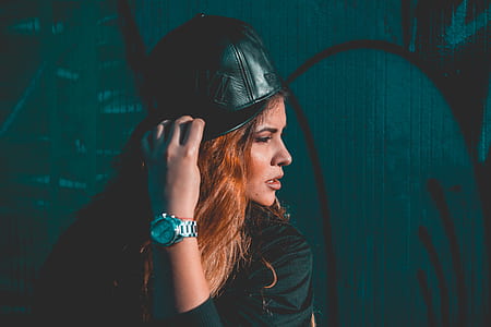 woman standing beside blue and black wall thumbnail