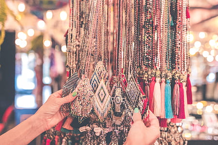 person holding necklaces thumbnail