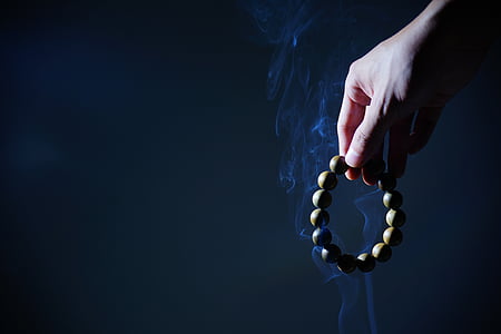 person holding beaded bracelet thumbnail