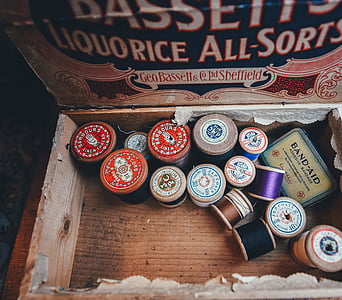 assorted-color thread lot on brown surface thumbnail